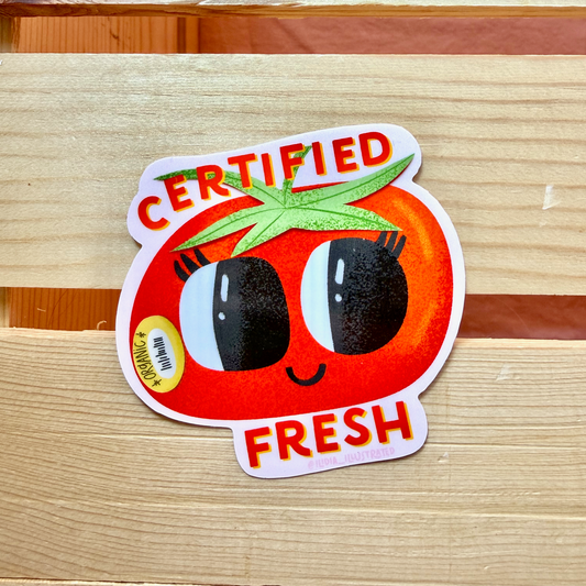 Certified Fresh tomato sticker on a wooden surface