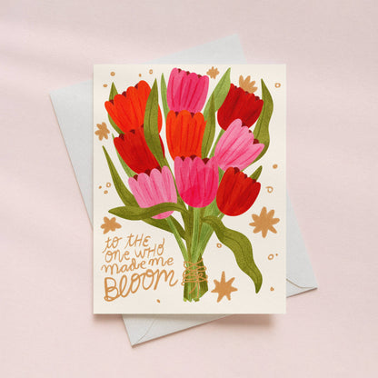 mothers day love Greeting card with red and pink tulips bouquet and text on a light pink background
