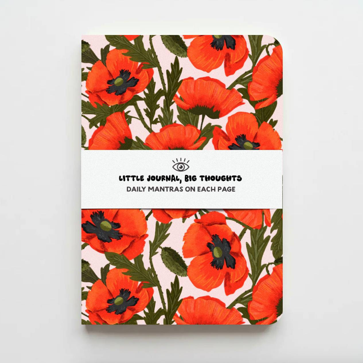 A hardcover daily journal with a vibrant poppy floral pattern in orange, red, and green on a cream background, featuring a white paper band across the middle with the text 'LITTLE JOURNAL, BIG THOUGHTS' and 'DAILY MANTRAS ON EACH PAGE'.