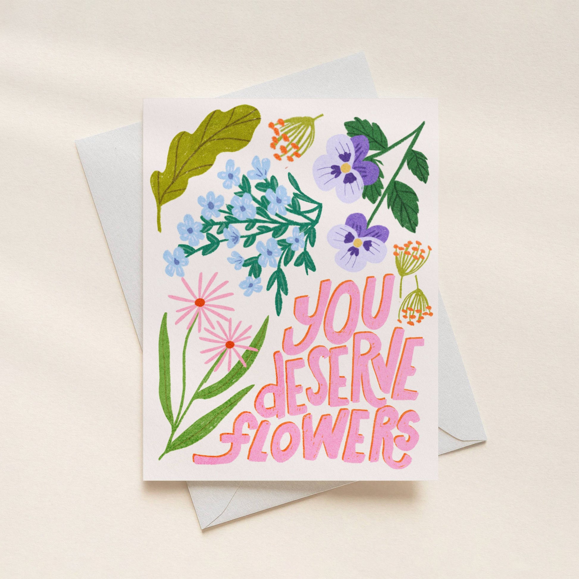 Greeting card with floral design and 'You Deserve Flowers' text on a beige background