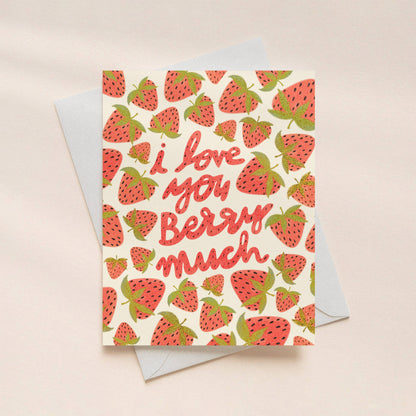 Greeting card with strawberry pattern and 'I love you berry much' text on a beige background