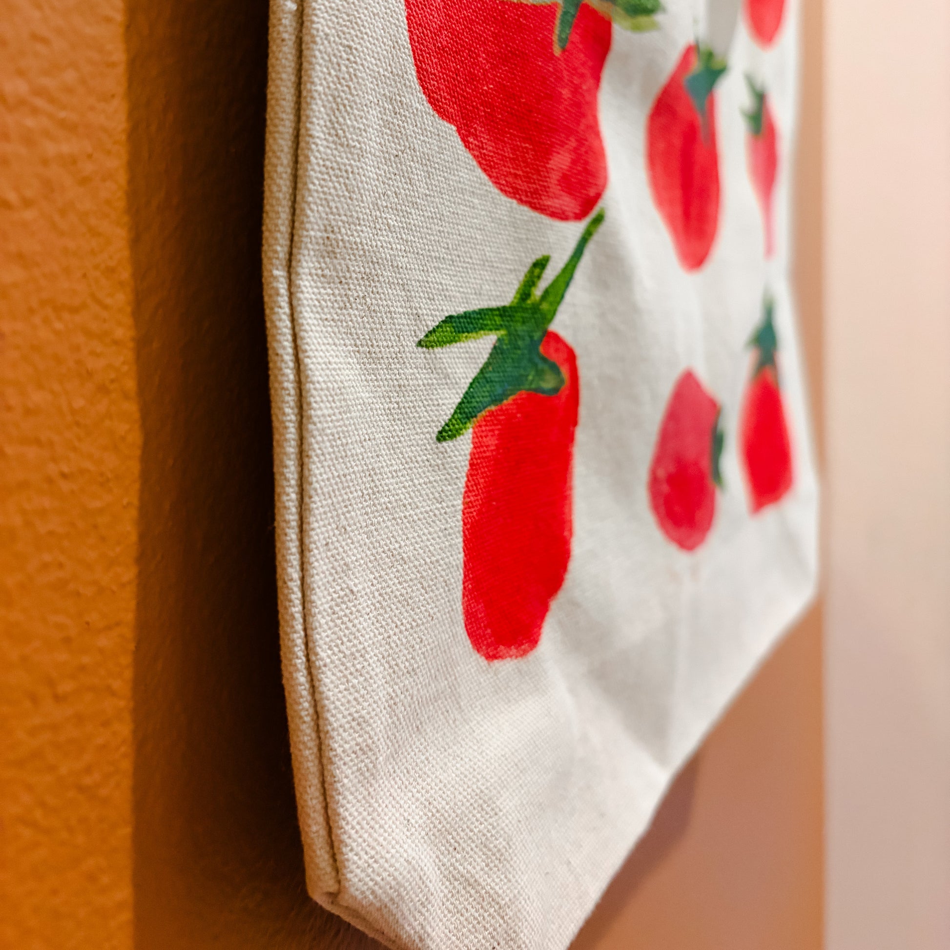Fabric with red tomato pattern on a beige background
